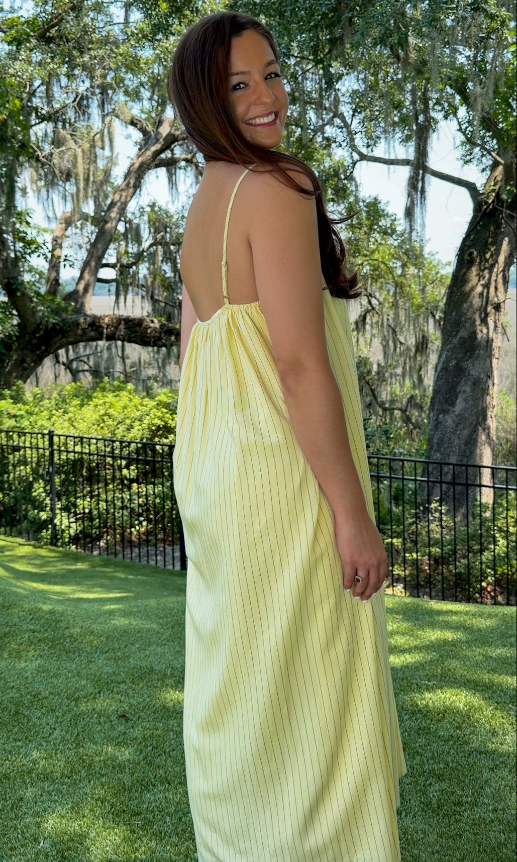 Butter yellow pinstripe maxi dress featuring adjustable spaghetti straps, a gathered square neckline, and a relaxed flowy silhouette in a lightweight woven fabric.