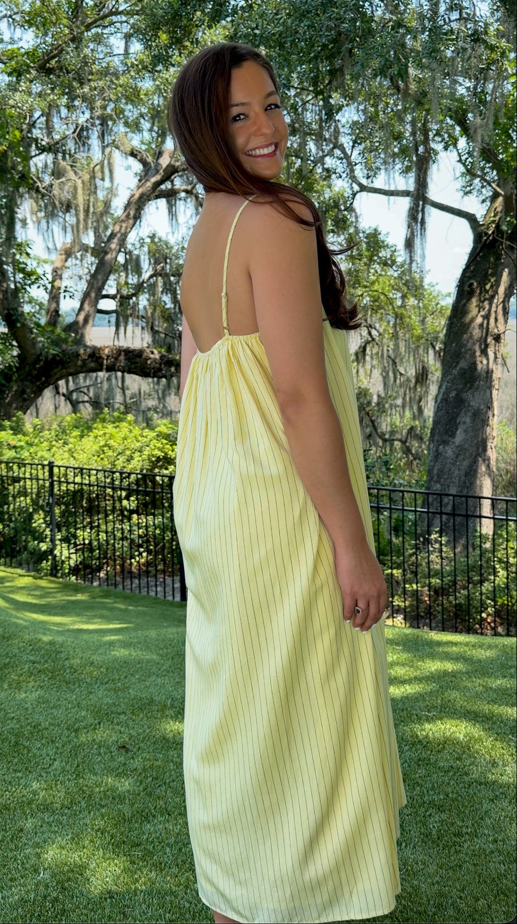 Butter yellow pinstripe maxi dress featuring adjustable spaghetti straps, a gathered square neckline, and a relaxed flowy silhouette in a lightweight woven fabric.