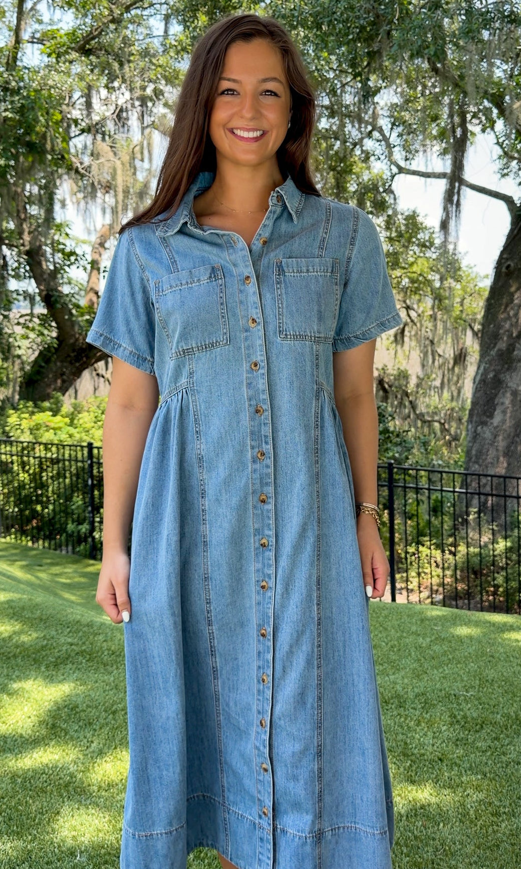 Light wash chambray midi dress featuring a collared neckline, functional button-front closure, oversized chest pockets, short sleeves, side pockets, and a relaxed silhouette.