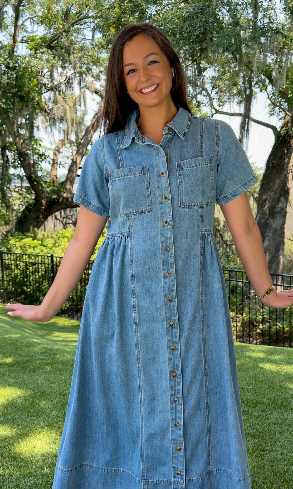 Light wash chambray midi dress featuring a collared neckline, functional button-front closure, oversized chest pockets, short sleeves, side pockets, and a relaxed silhouette.