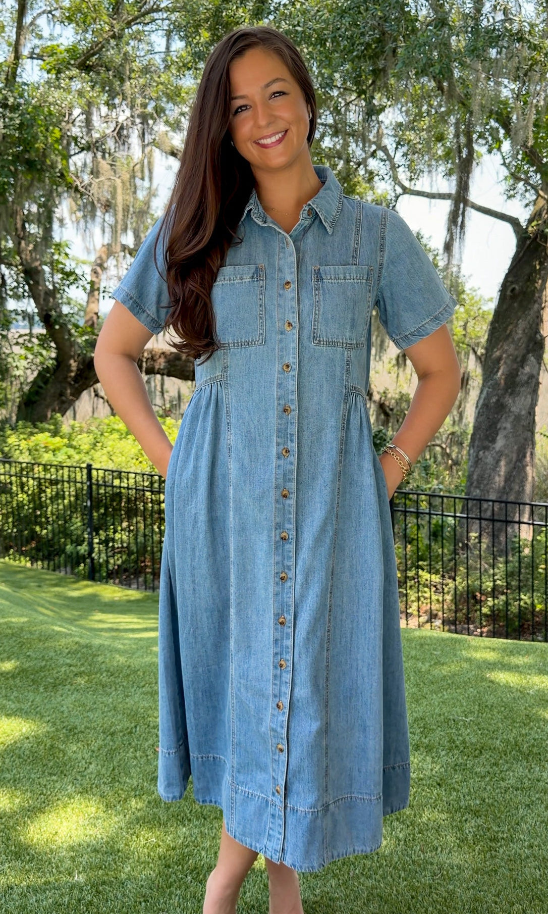 Light wash chambray midi dress featuring a collared neckline, functional button-front closure, oversized chest pockets, short sleeves, side pockets, and a relaxed silhouette.