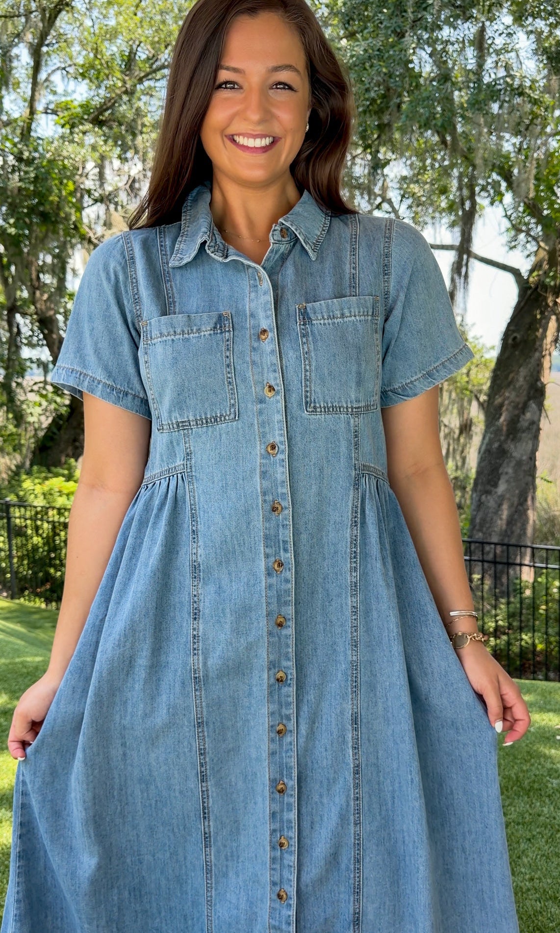 Light wash chambray midi dress featuring a collared neckline, functional button-front closure, oversized chest pockets, short sleeves, side pockets, and a relaxed silhouette.