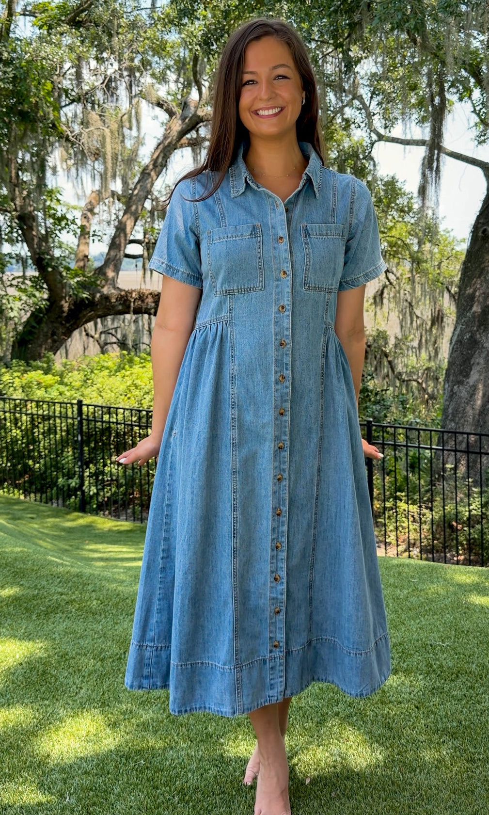 Light wash chambray midi dress featuring a collared neckline, functional button-front closure, oversized chest pockets, short sleeves, side pockets, and a relaxed silhouette.