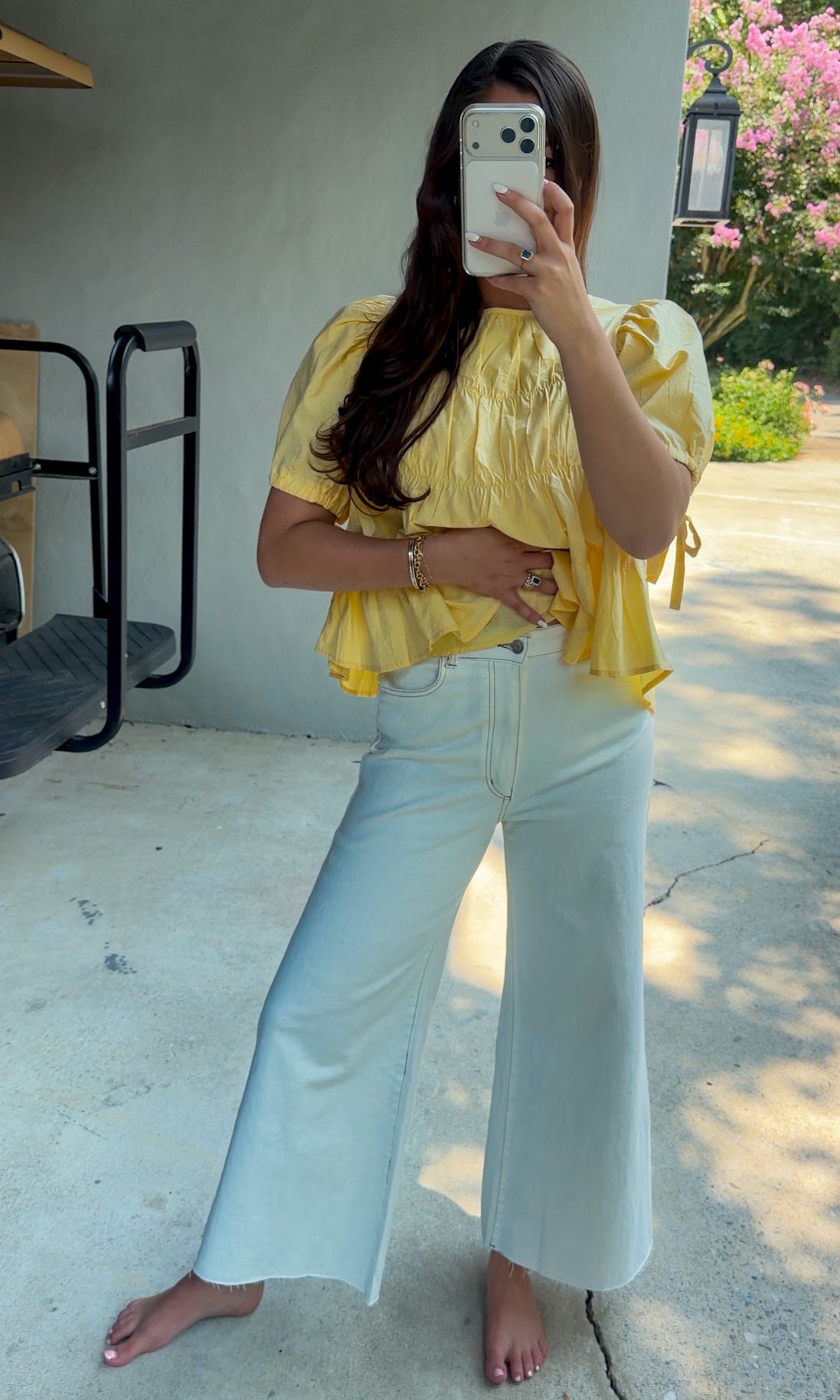 White high-rise wide leg denim jeans featuring contrast stitching, a cropped raw hem, front and back pockets, and a flattering structured fit.