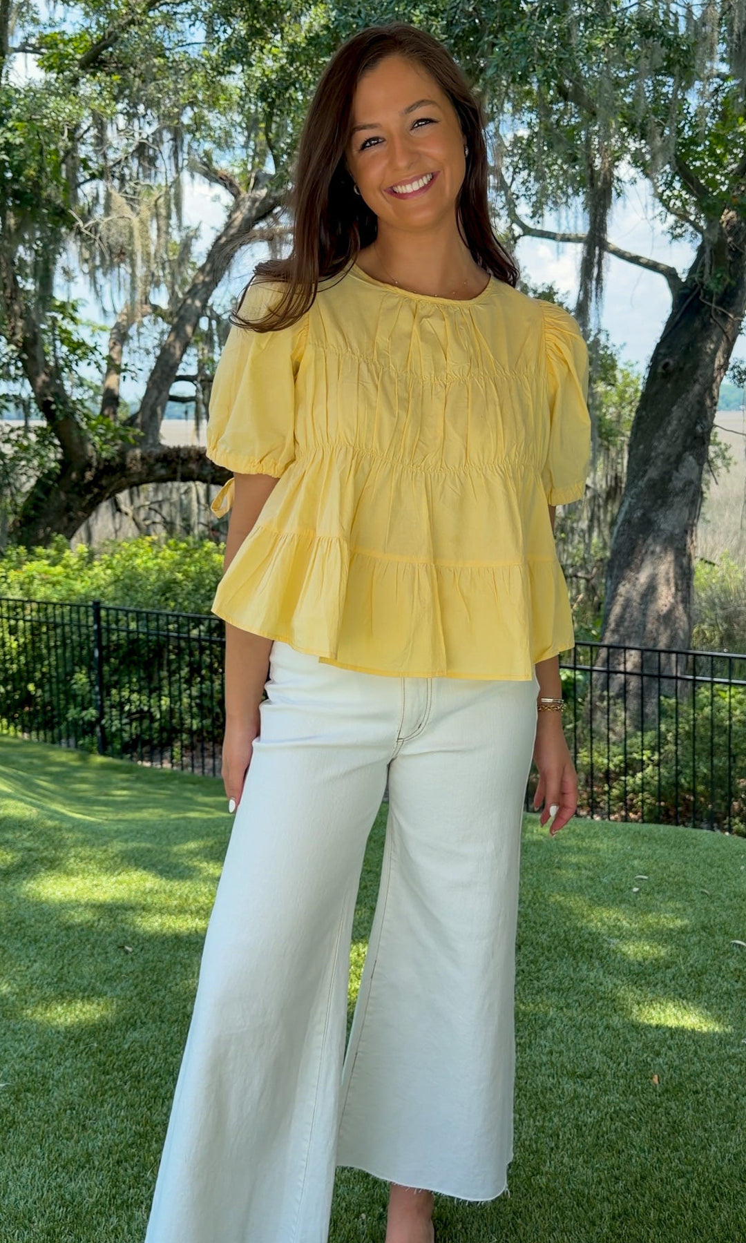 White high-rise wide leg denim jeans featuring contrast stitching, a cropped raw hem, front and back pockets, and a flattering structured fit.