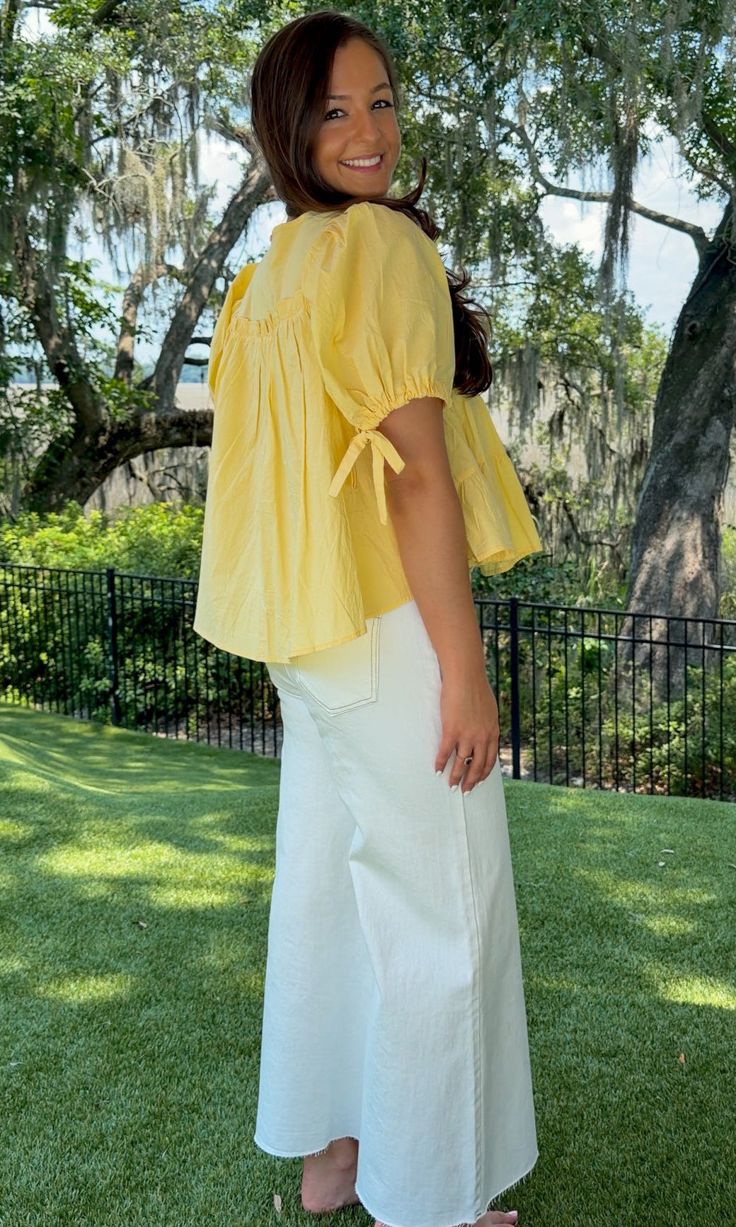 White high-rise wide leg denim jeans featuring contrast stitching, a cropped raw hem, front and back pockets, and a flattering structured fit.