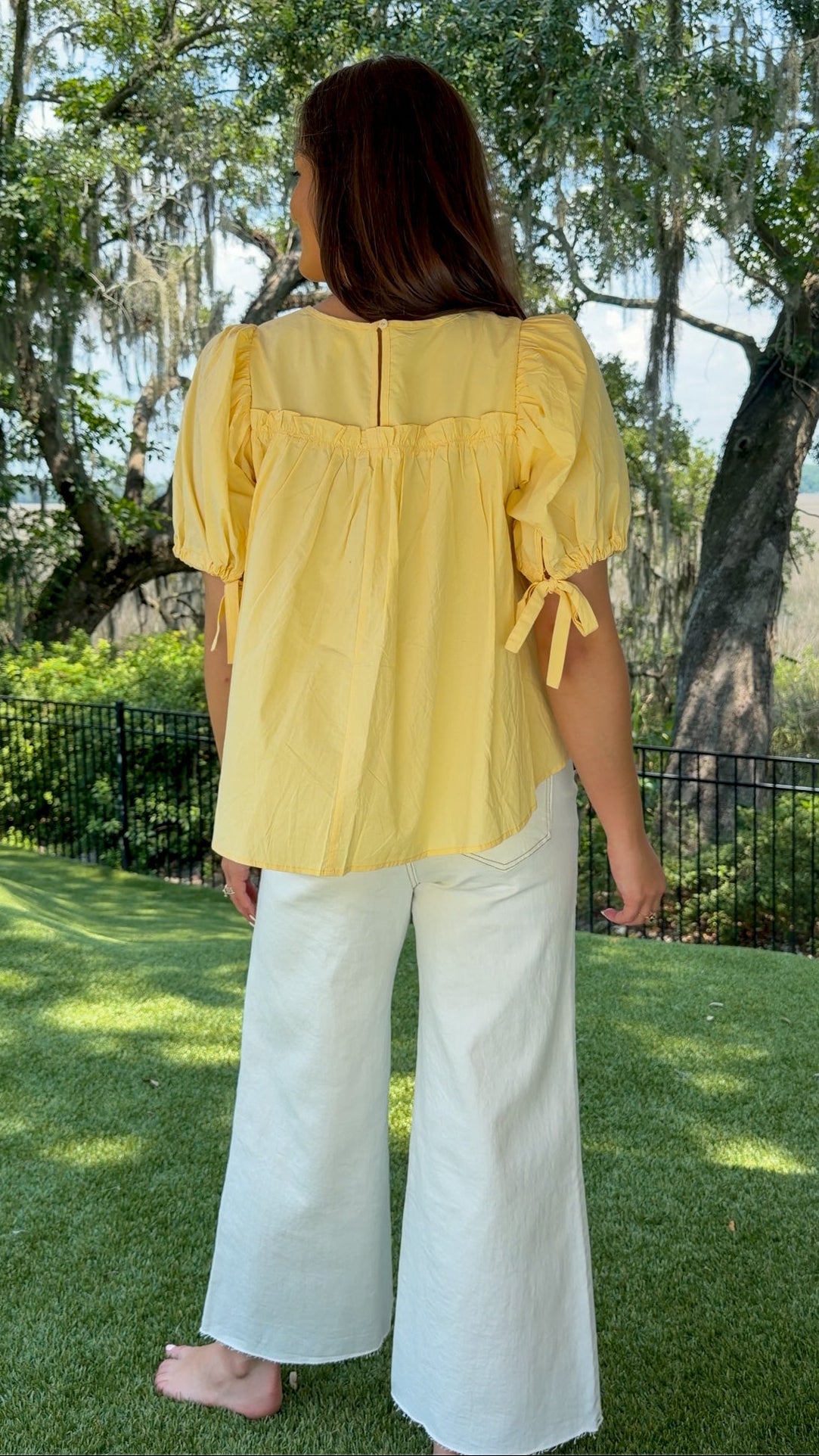 White high-rise wide leg denim jeans featuring contrast stitching, a cropped raw hem, front and back pockets, and a flattering structured fit.