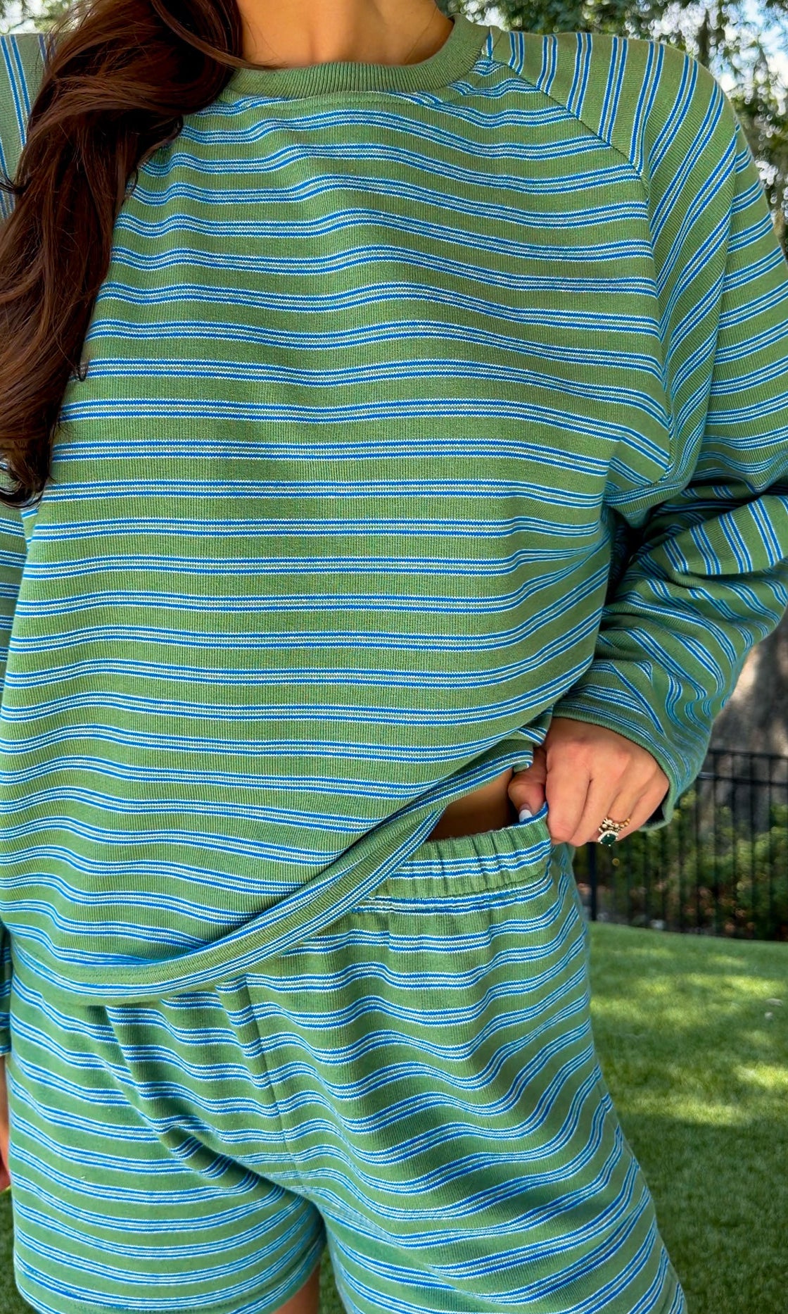Olive and blue striped lounge set featuring a relaxed fit long sleeve crewneck top and matching elastic waist shorts with side pockets in a soft stretch knit fabric.