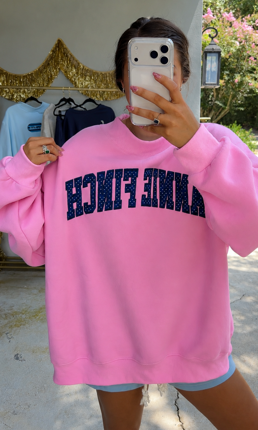 pink mockneck sweatshirt with navy and white polka dot "annie finch" embroidery