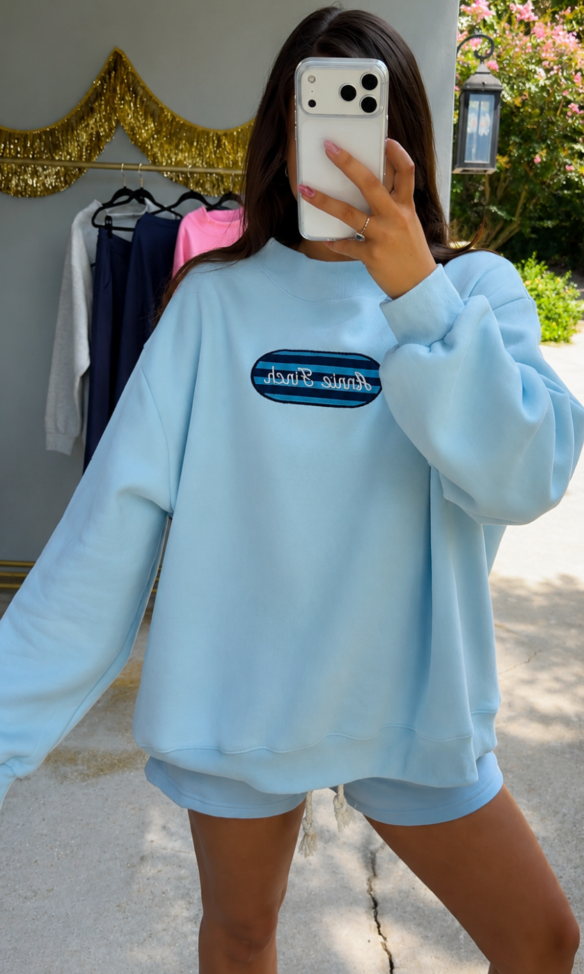 light blue mockneck sweatshirt with striped patch annie finch embroidery