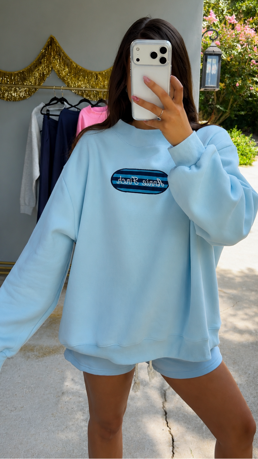 light blue mockneck sweatshirt with striped patch annie finch embroidery