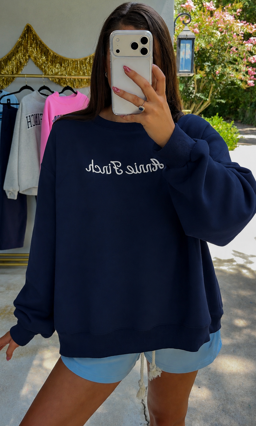 navy crewneck with white "annie finch" script embroidered on front