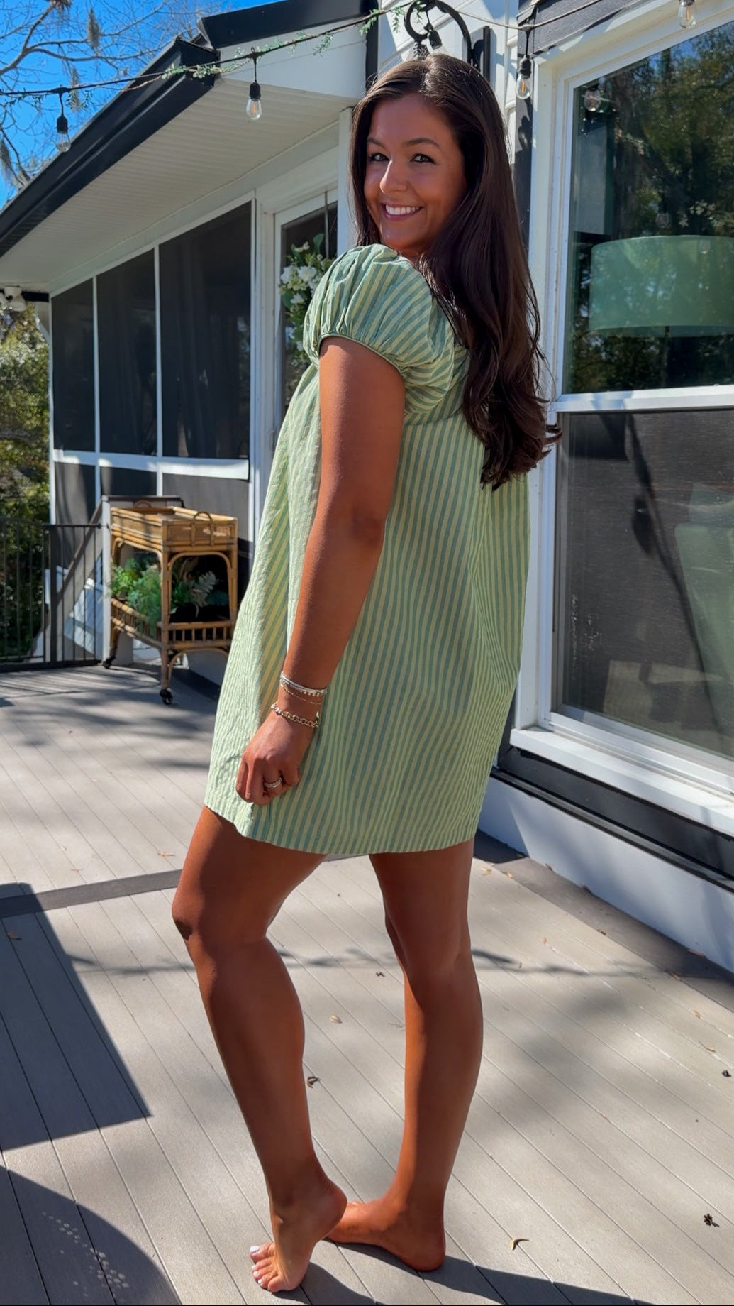 green striped babydoll mini dress with gathered neckline and pockets