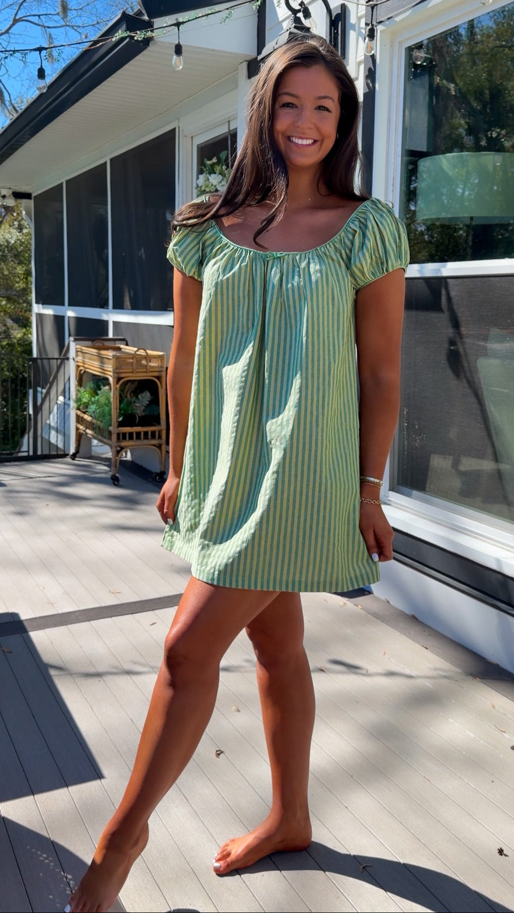 green striped babydoll mini dress with gathered neckline and pockets