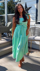 green striped tiered midi dress with bow tie straps and smocked back