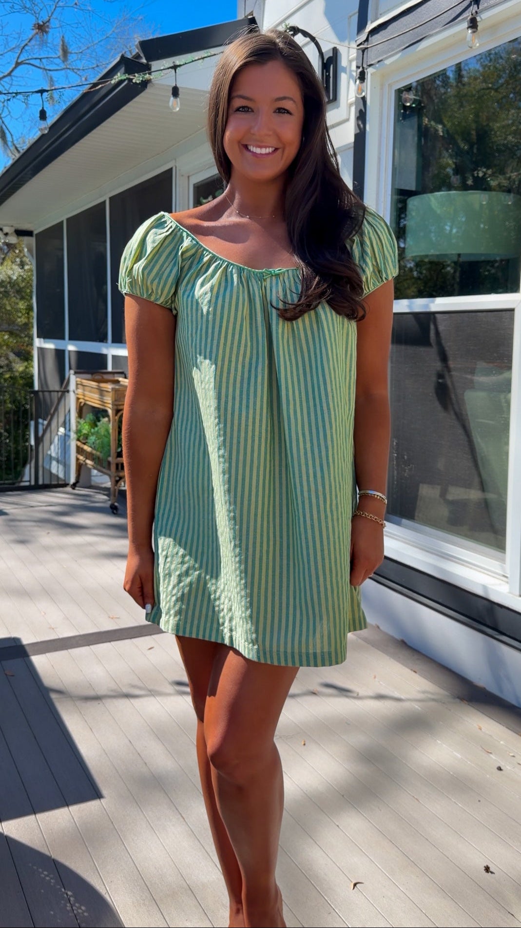 green striped babydoll mini dress with gathered neckline and pockets