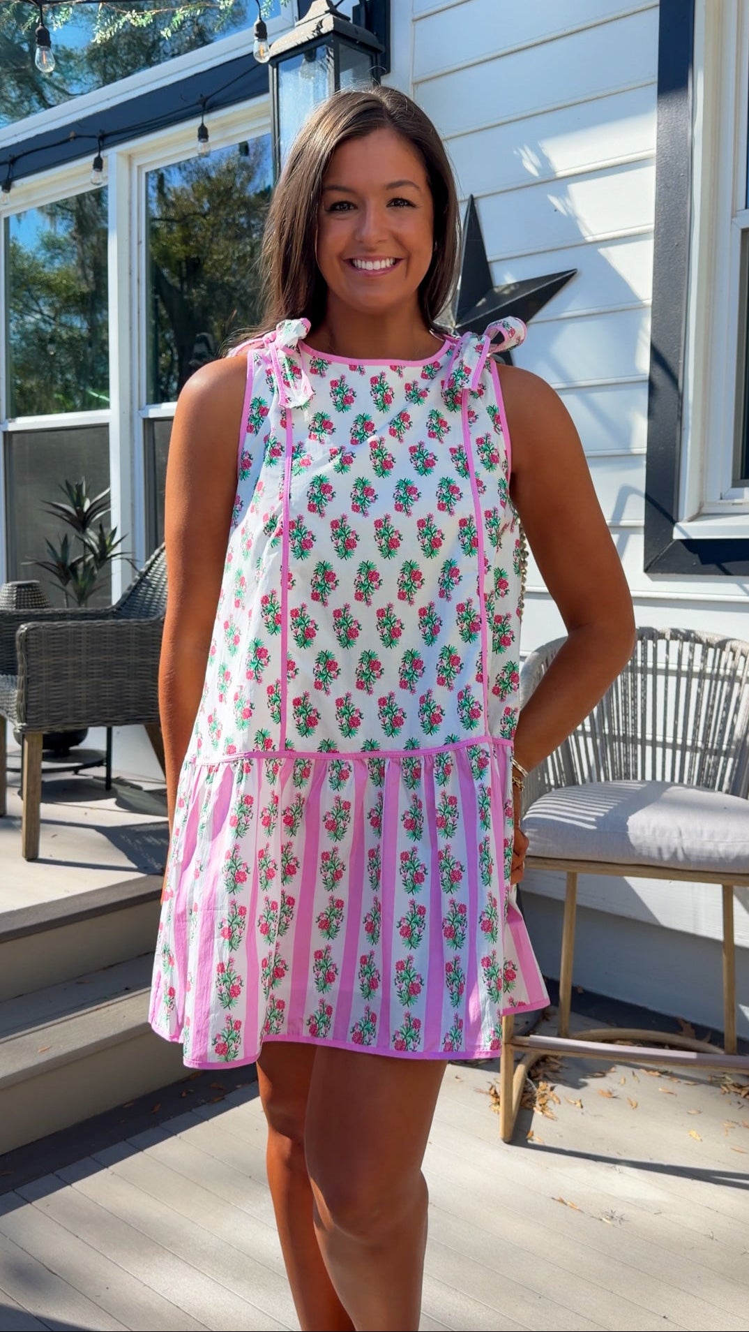 pink floral mini dress with ruffle hem and decorative shoulder bows