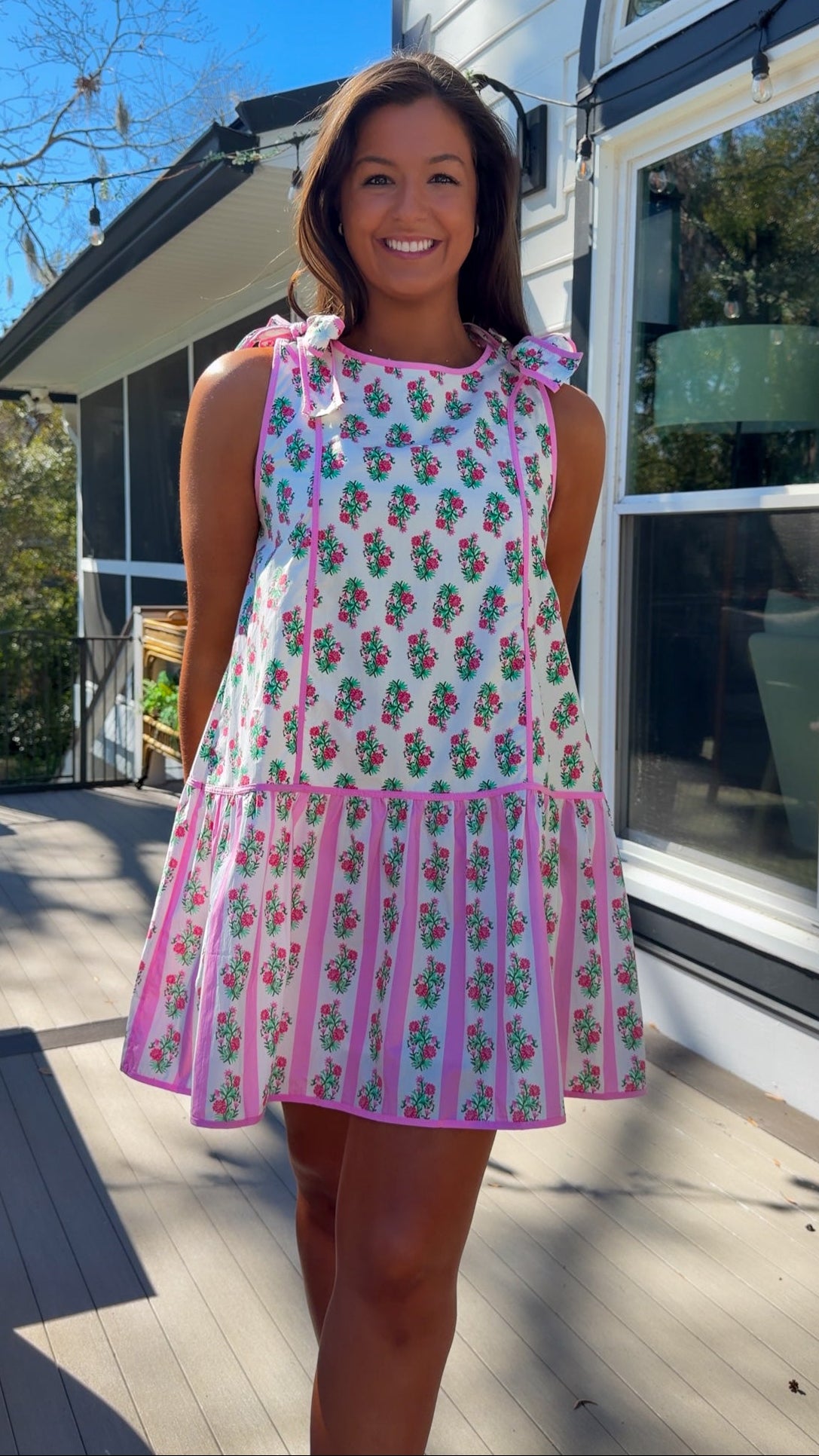 pink floral mini dress with ruffle hem and decorative shoulder bows