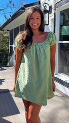 green striped babydoll mini dress with gathered neckline and pockets