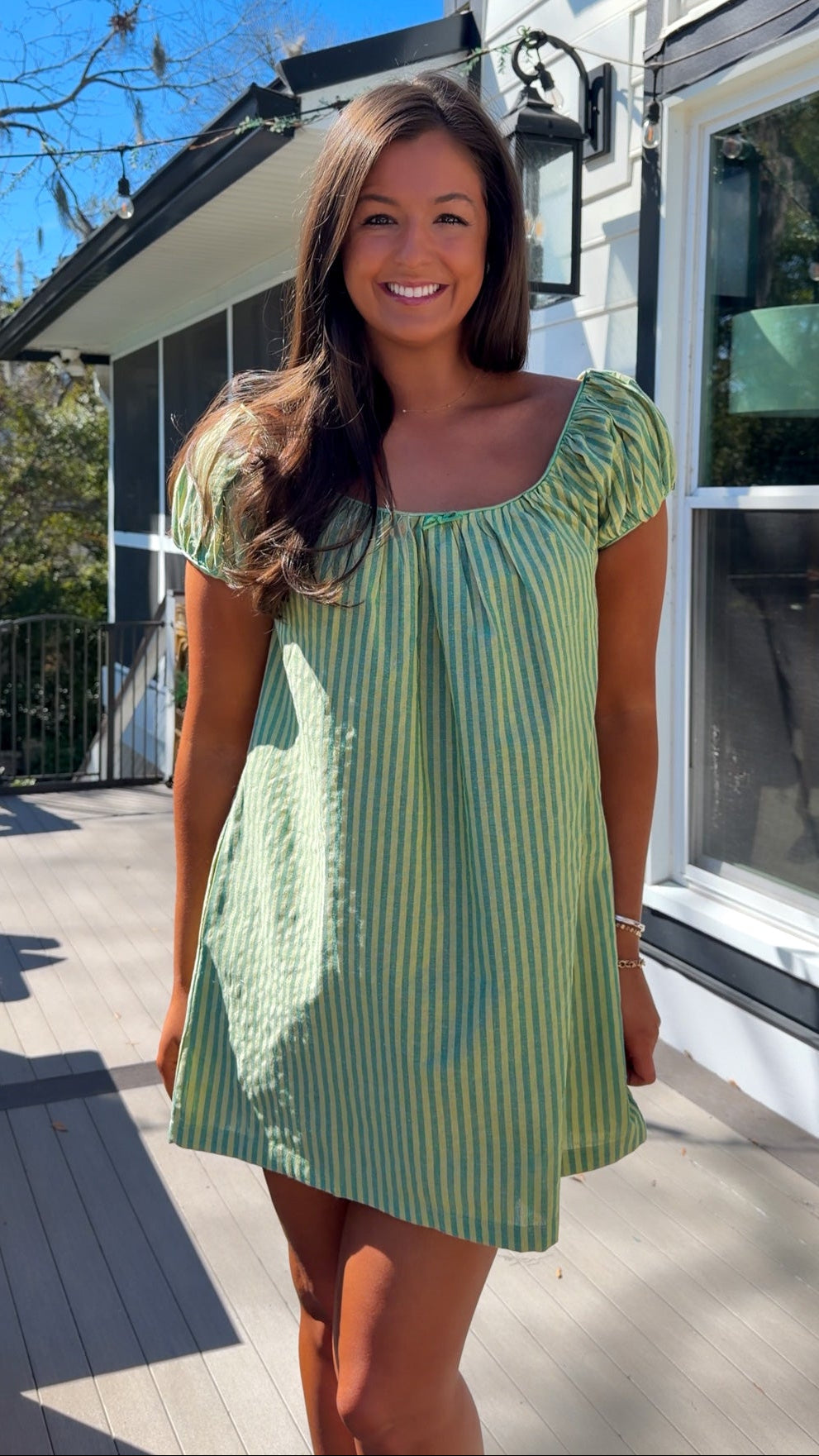 green striped babydoll mini dress with gathered neckline and pockets