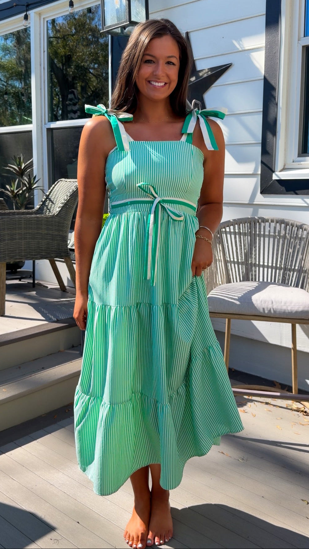 green striped tiered midi dress with bow tie straps and smocked back