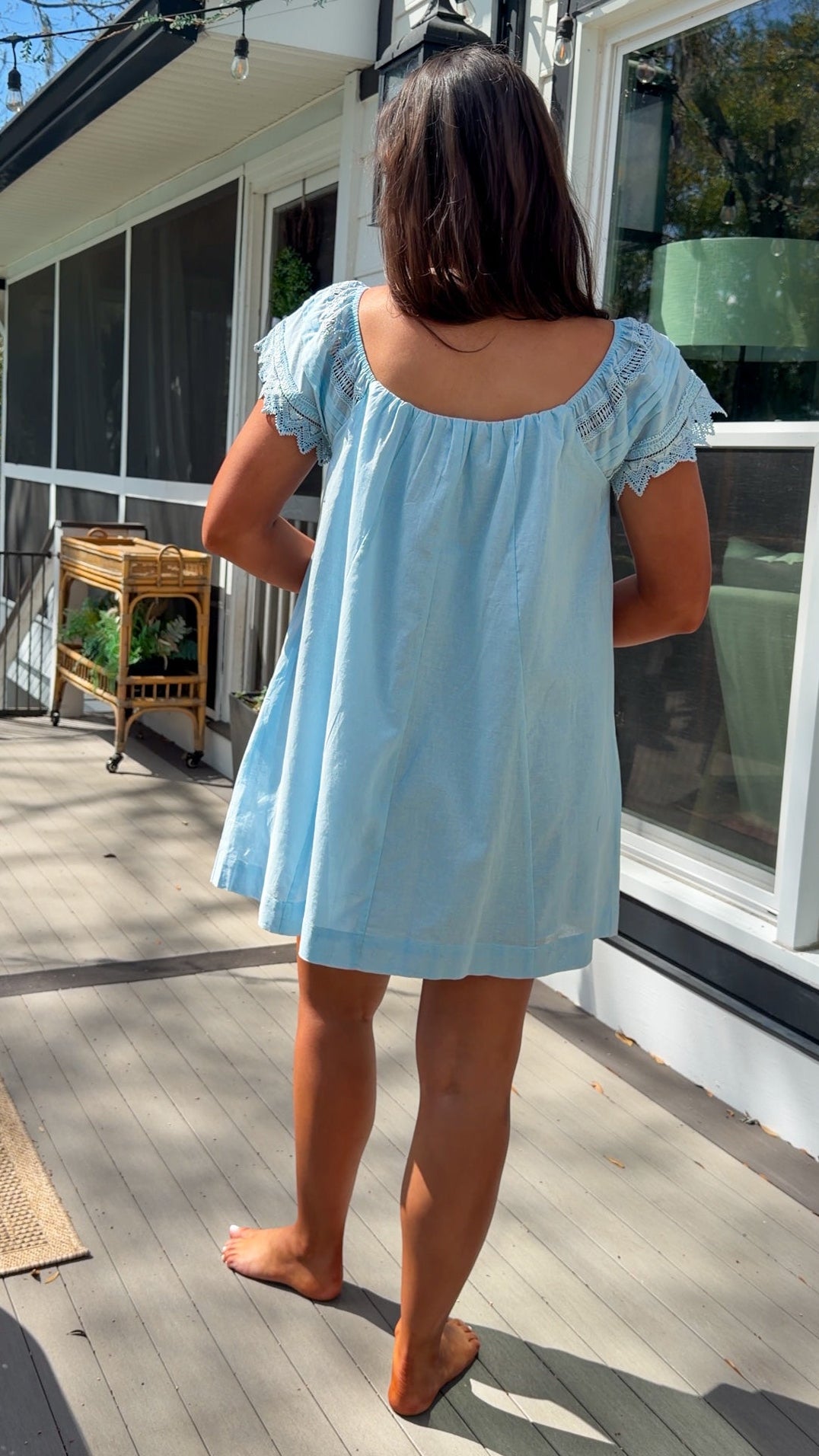 light blue linen blend mini dress with eyelet lace trim sleeves and tie neckline