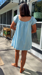 light blue linen blend mini dress with eyelet lace trim sleeves and tie neckline