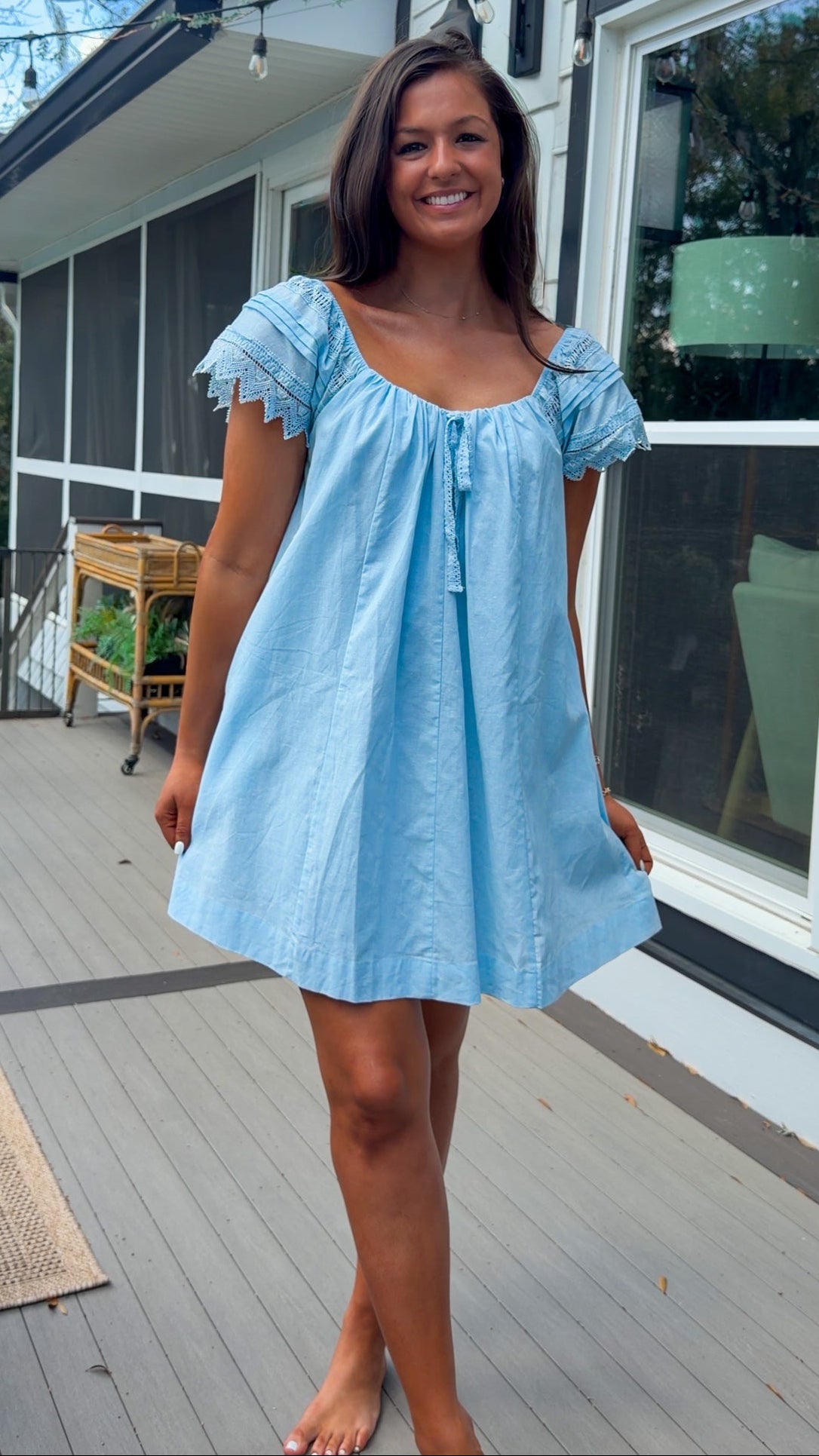light blue linen blend mini dress with eyelet lace trim sleeves and tie neckline