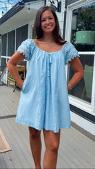 light blue linen blend mini dress with eyelet lace trim sleeves and tie neckline