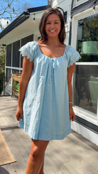 light blue linen blend mini dress with eyelet lace trim sleeves and tie neckline