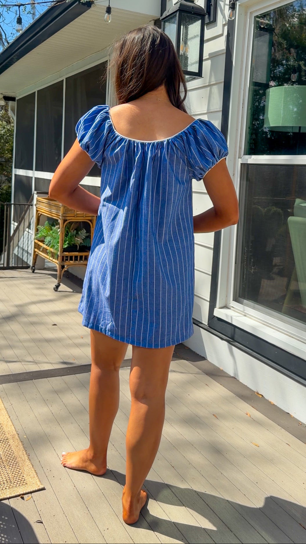 blue stripe babydoll mini dress with gathered neckline short sleeves and side pockets