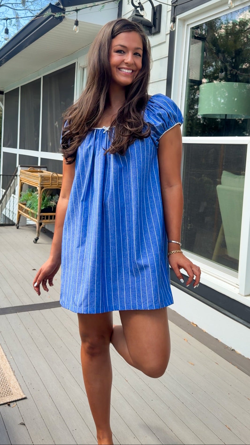 blue stripe babydoll mini dress with gathered neckline short sleeves and side pockets