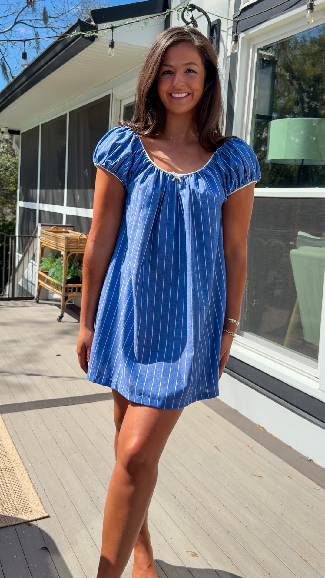 blue stripe babydoll mini dress with gathered neckline short sleeves and side pockets