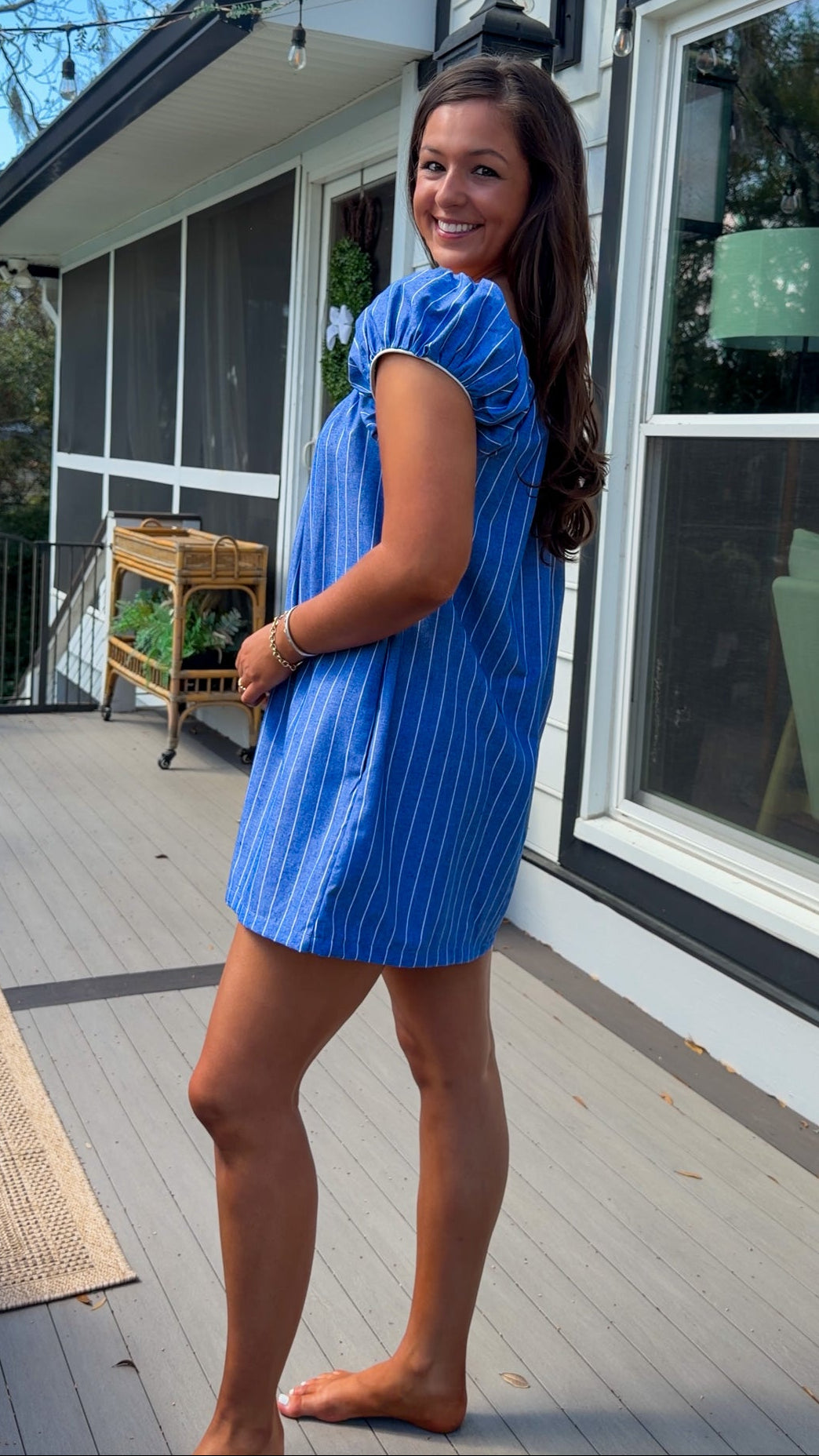 blue stripe babydoll mini dress with gathered neckline short sleeves and side pockets