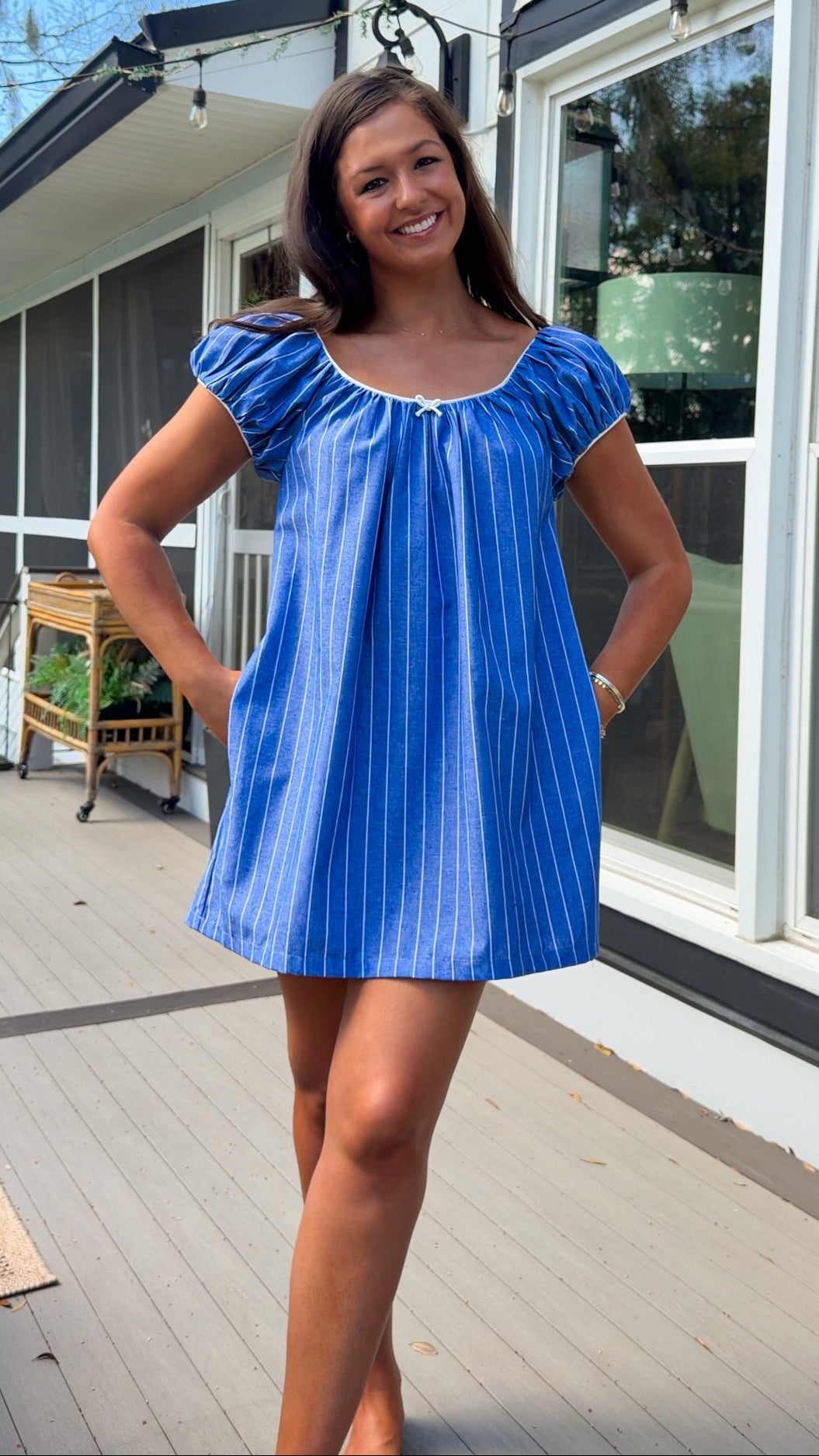 blue stripe babydoll mini dress with gathered neckline short sleeves and side pockets