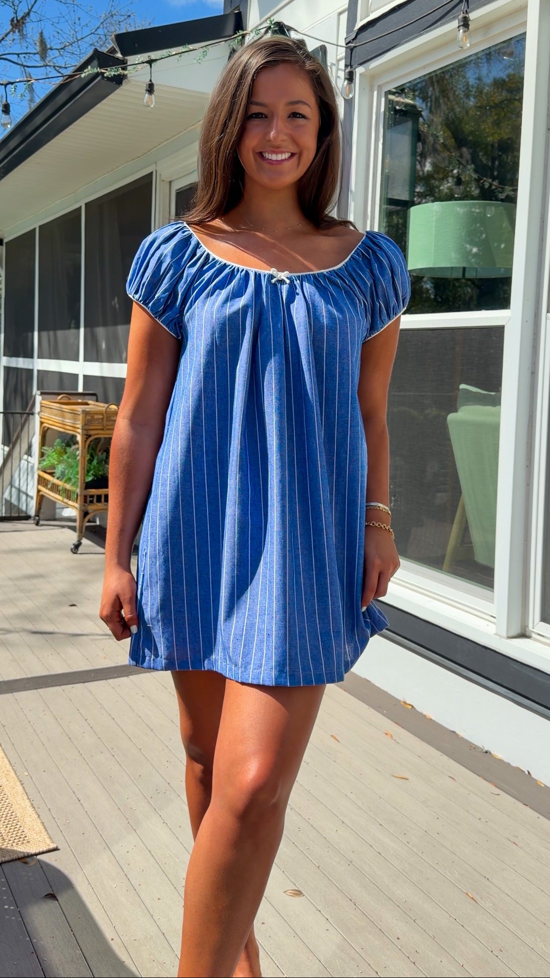 blue stripe babydoll mini dress with gathered neckline short sleeves and side pockets