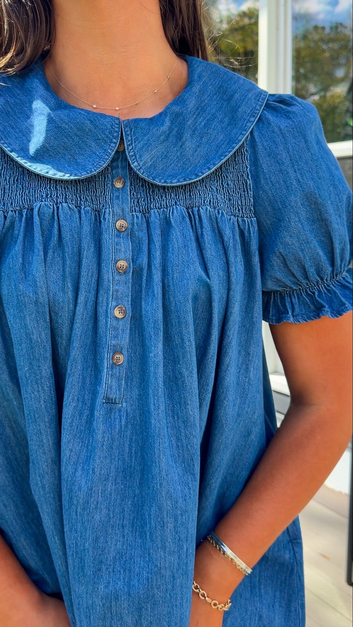 denim mini dress with peter pan collar puff sleeves button front and smocked back detail