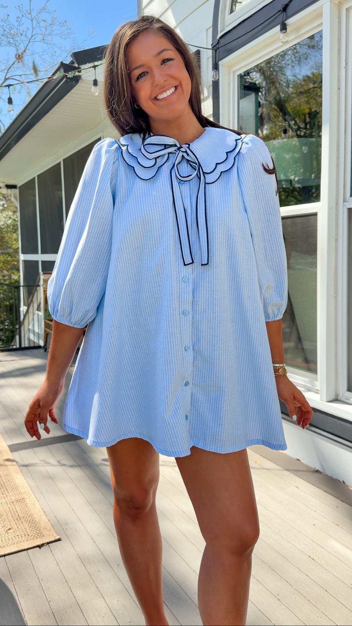 light blue striped mini dress with scalloped collar contrast trim bow tie and button front