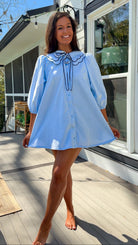 light blue striped mini dress with scalloped collar contrast trim bow tie and button front
