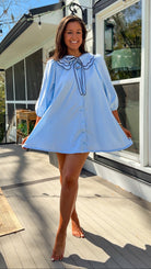 light blue striped mini dress with scalloped collar contrast trim bow tie and button front