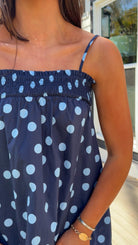 midnight blue polka dot maxi dress with smocked bodice and adjustable spaghetti straps