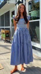 navy striped midi dress with smocked bodice ruffle sleeves and tiered skirt