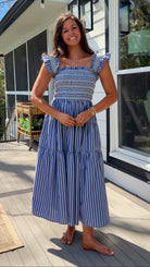 navy striped midi dress with smocked bodice ruffle sleeves and tiered skirt