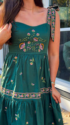 green dress floral embroidery closeup 