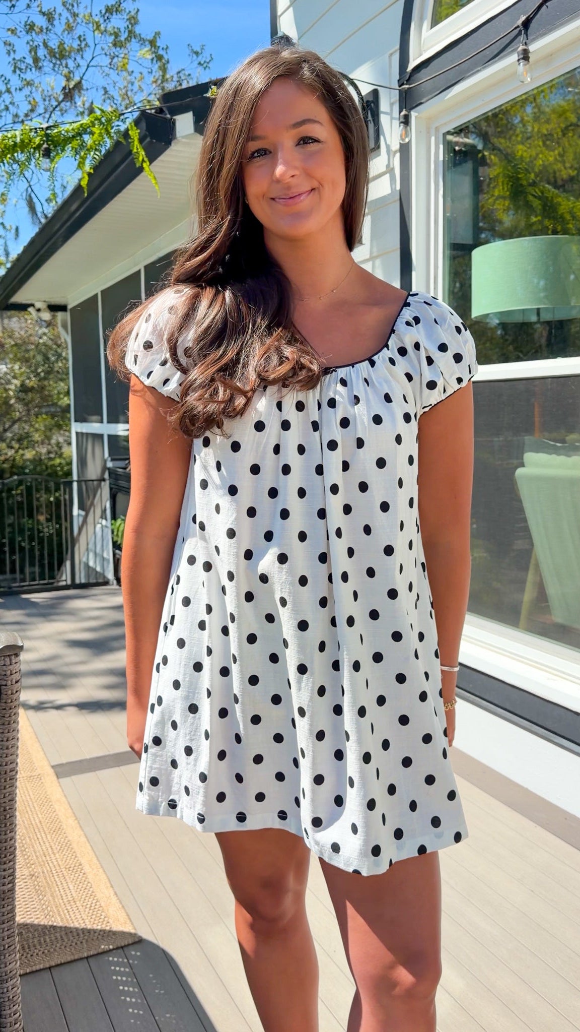 white and black polka dot mini dress with black bow