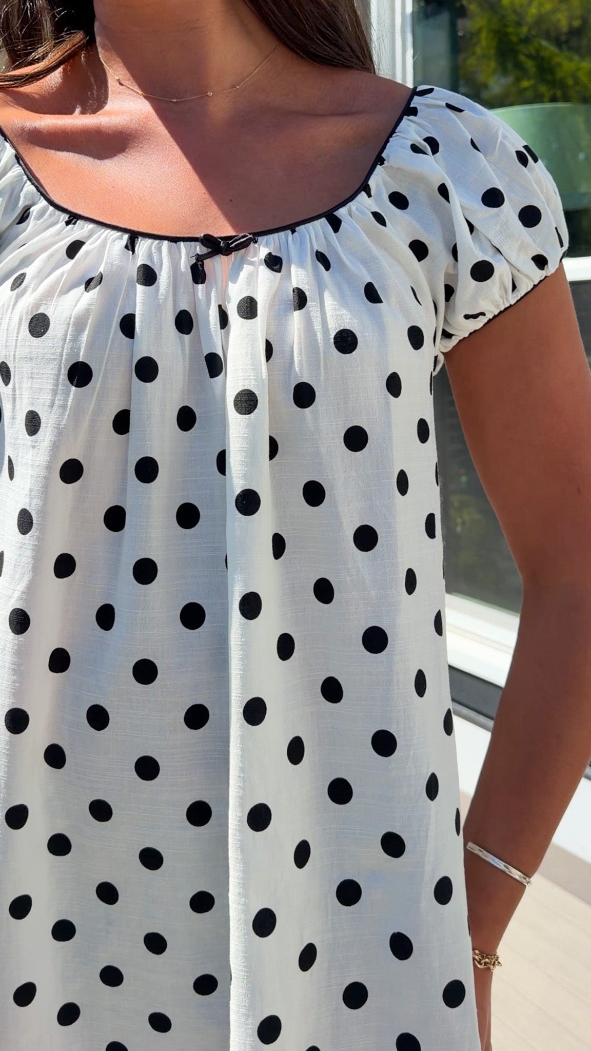 white and black polka dot mini dress with black bow