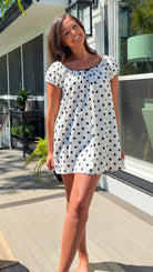 white and black polka dot mini dress with black bow