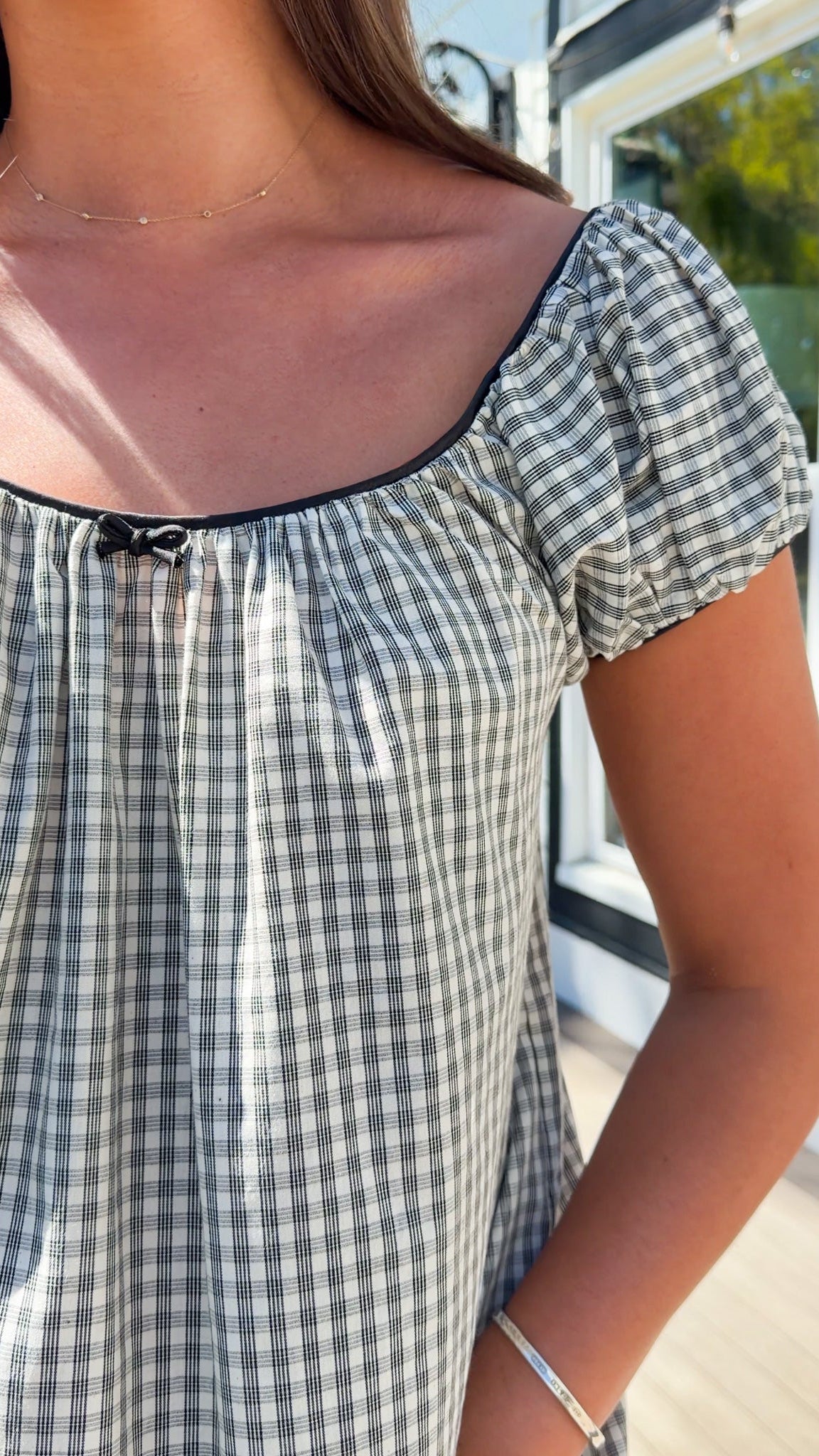 black and white gingham mini dress with cap sleeves and bow