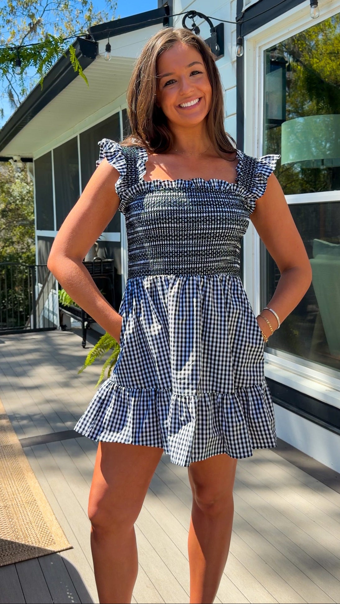 black and white gingham smocked mini dress with ruffle straps and flowy skirt and built in shorts