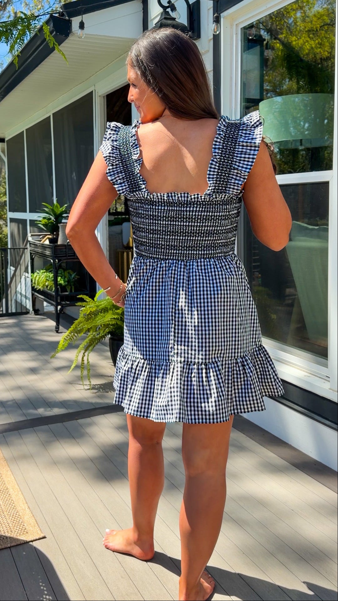 black and white gingham smocked mini dress with ruffle straps and flowy skirt and built in shorts